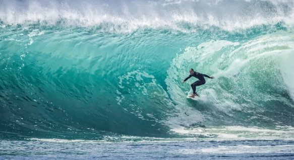 a man surfs the waves